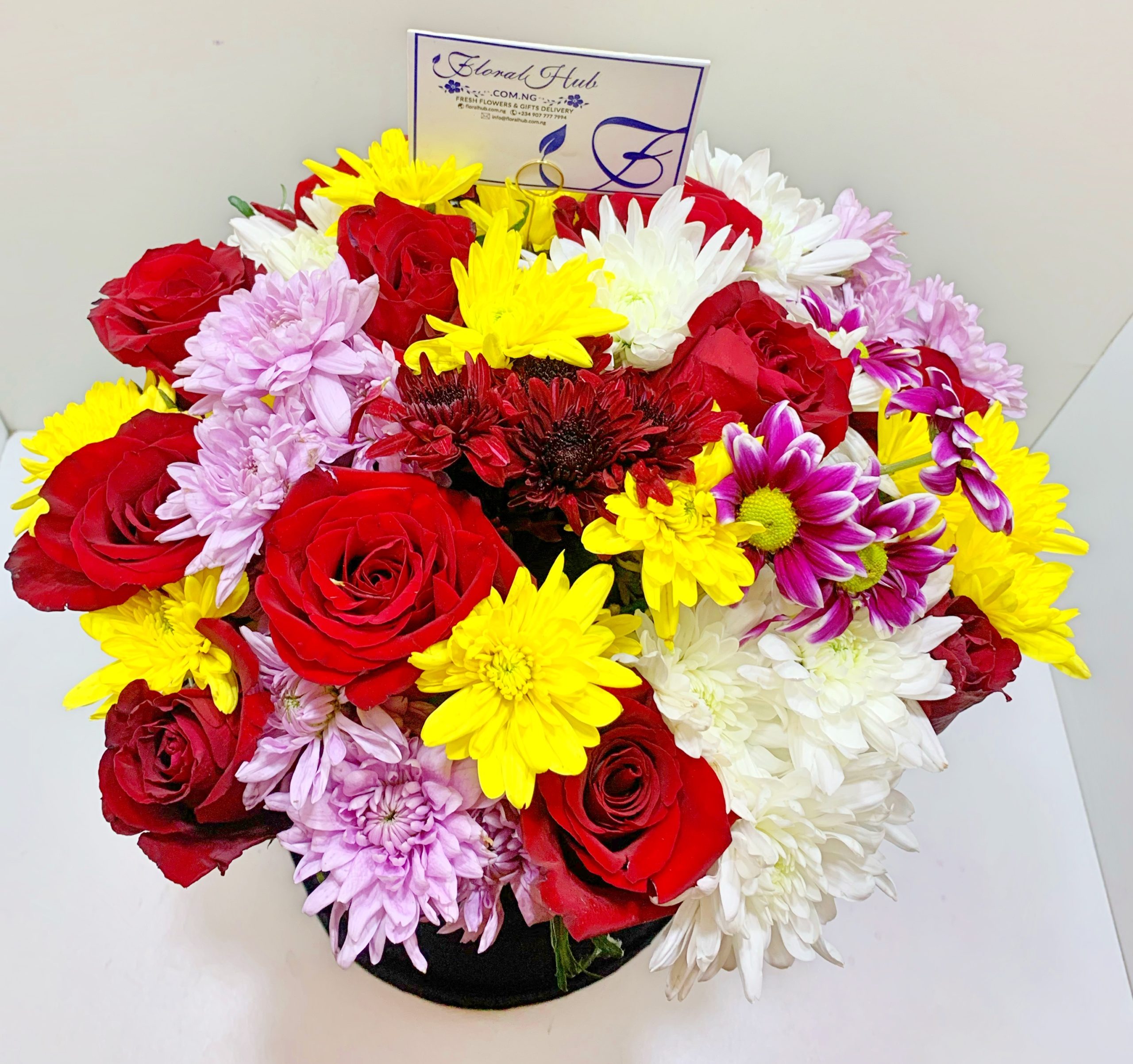 VIP Dune Box is a beautiful arrangement of roses with mixed chrysanthemums and million stars