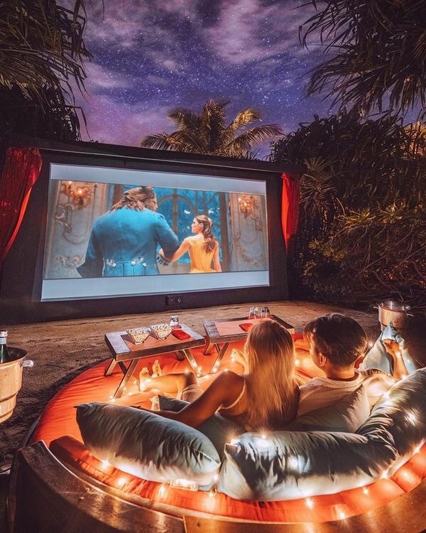 COUPLES WATCHING MOVIE IN A ROMANTIC WAY