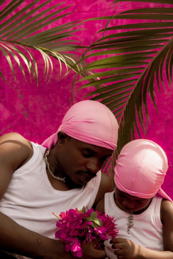 father and son wearing pink bonding