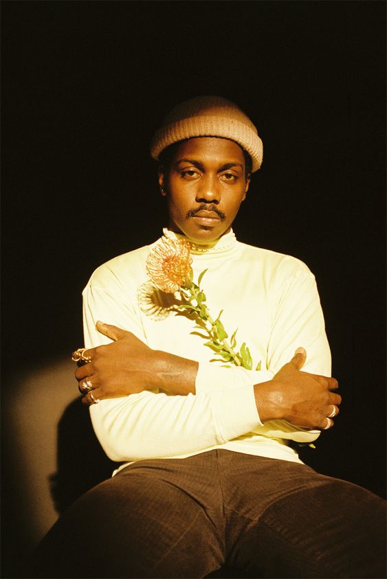 black man sitting with flowers